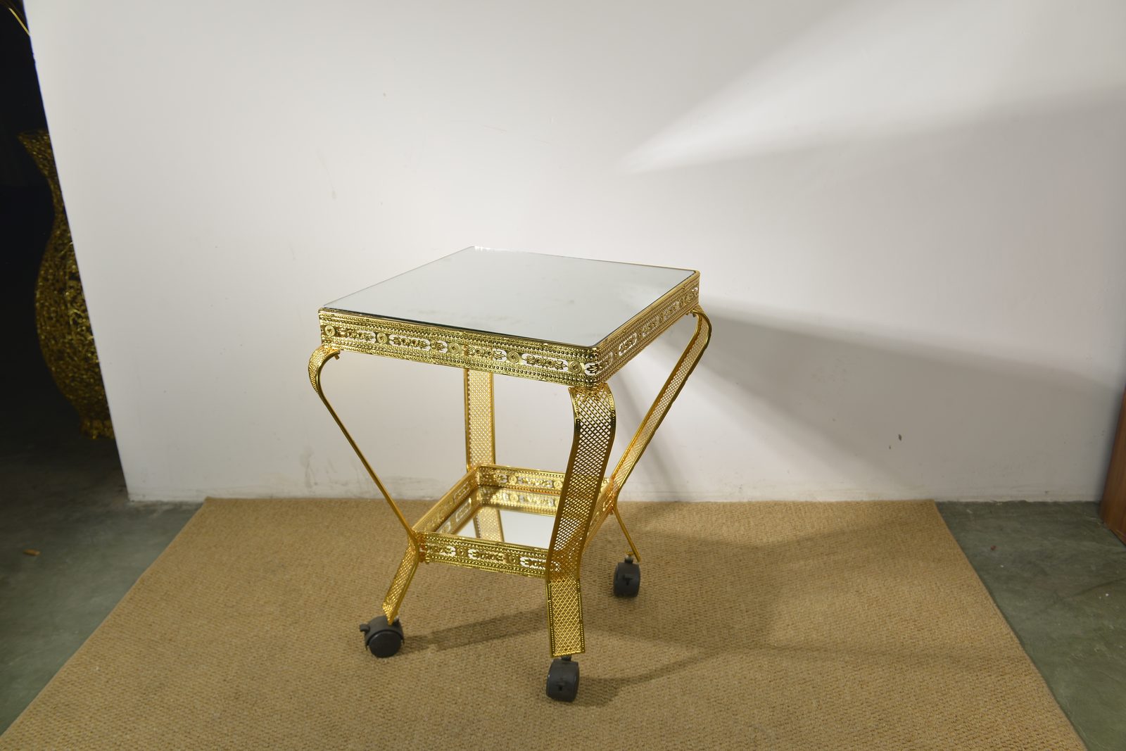 Custom-colour gold metal coffee table samples on factory floor